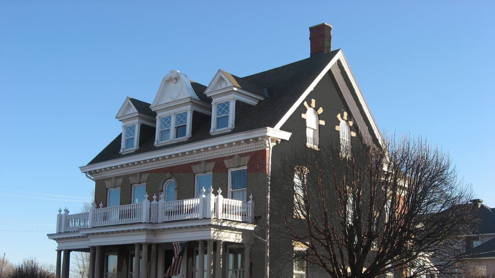 Brick colonial revival with a full-width balcony, repainted: brick Iron Ore SW 7069