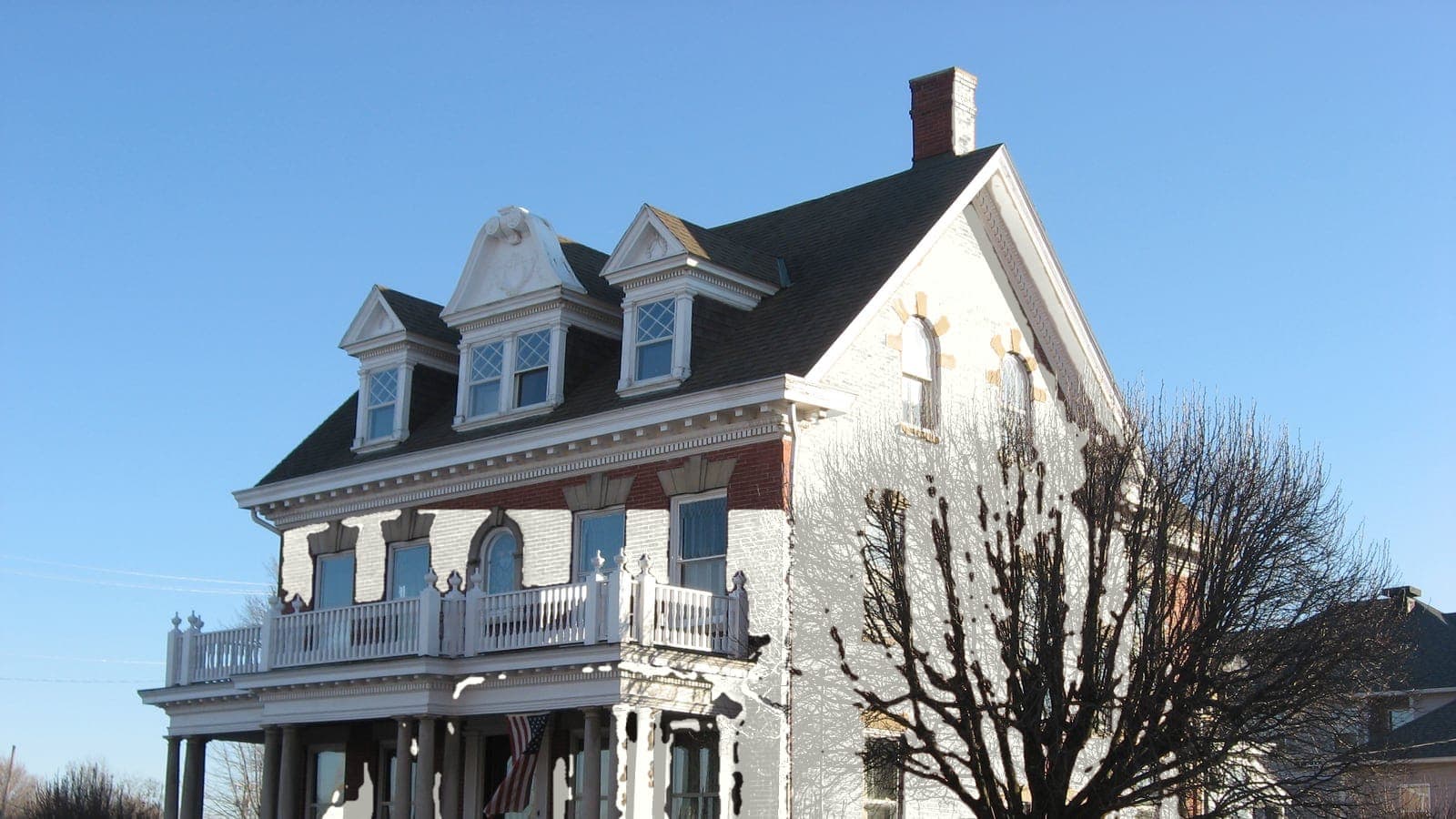 Brick colonial revival with a full-width balcony, repainted: brick White Dove OC-17
