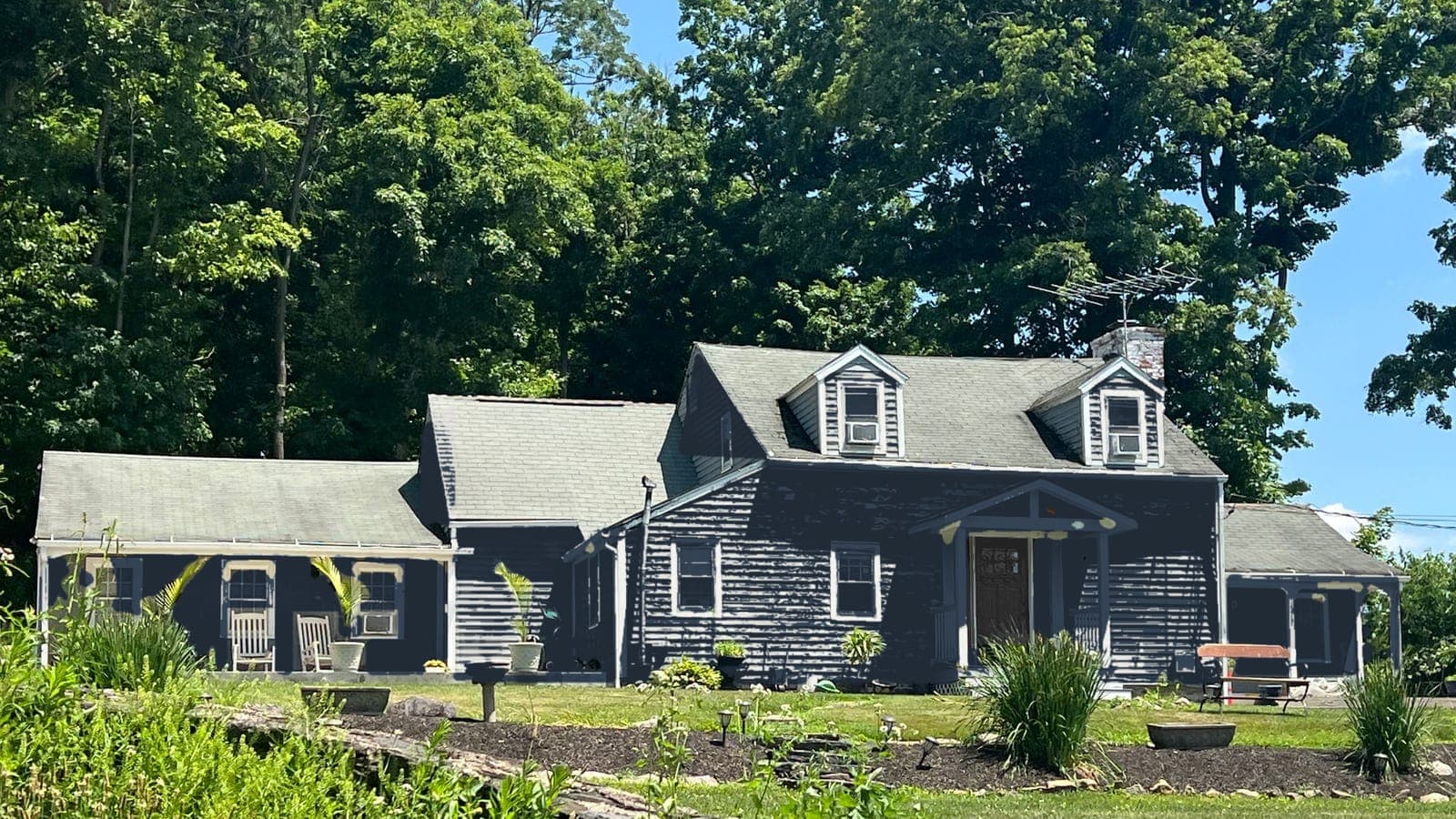 Sample house after: siding Naval SW 6244, trim Pure White SW 7005, front door Tricorn Black SW 6258