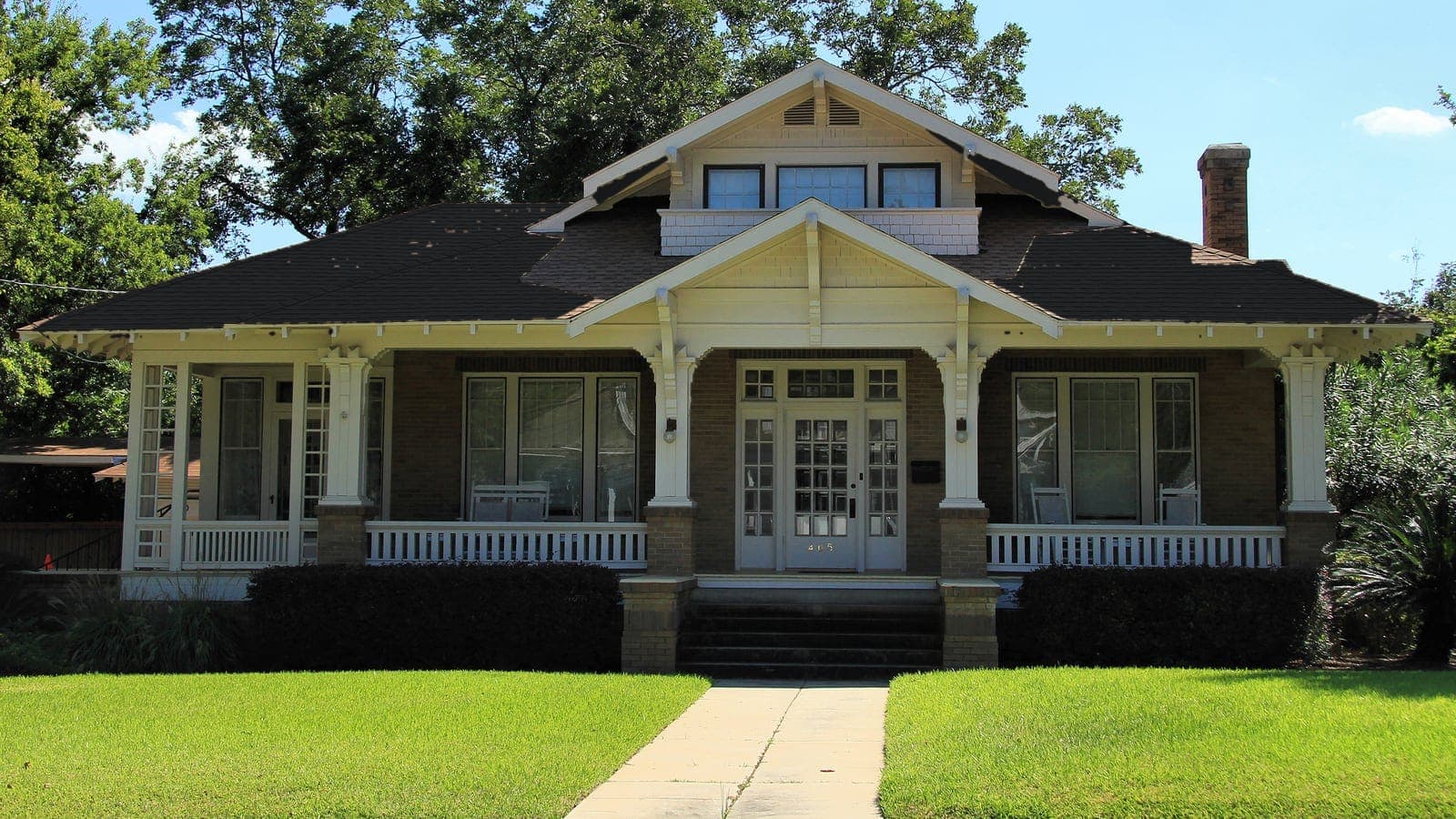 Craftsman bungalow with a brick porch and shingle roof, repainted: roof Onyx Black (shingle)